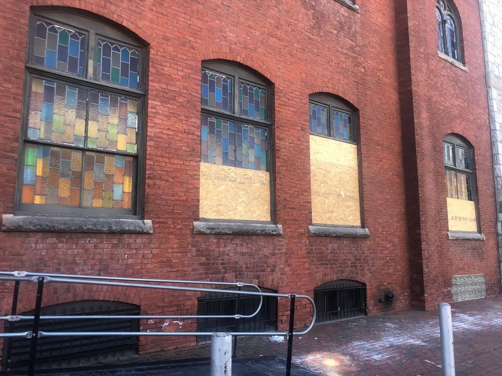 The stained-glass windows of Mother Bethel AME Church are boarded up on Feb. 20, 2024, after it was vandalized.