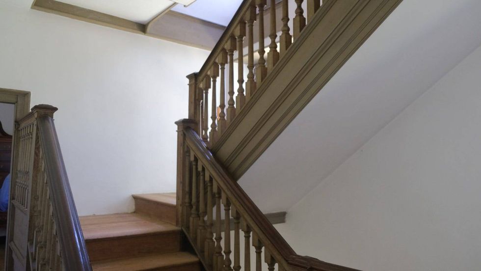 The stairwell of the Keith House, built in the 18th century, where a visitor reported she once experienced an unexplainable cold "whoosh" of air shortly after the death of one of the house