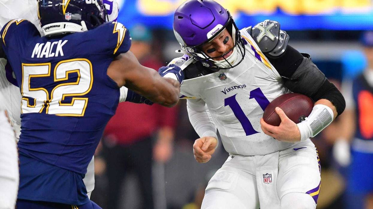 The start of a long time for Carson Wentz and the Vikings as Chargers linebacker Khalil Mack (52) tackles the quarterback during the first half at SoFi Stadium.