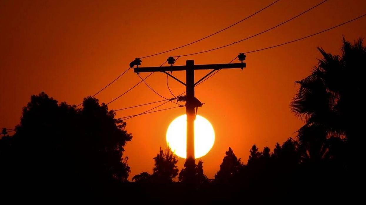 The sun sets behind power lines in Los Angeles on September 3, 2020, ahead of a Labor Day heatwave prompting statewide Flex Alerts.