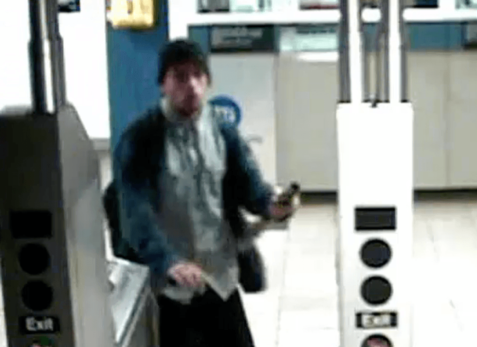 The suspect appears to be holding the metal pipe in surveillance footage from the station