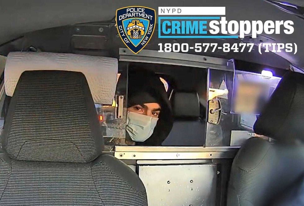 The suspect is seen in a taxi cab before the shooting