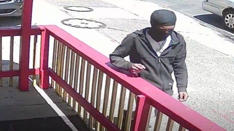 The suspect is shown in surveillance video in which police point out his black New Balance sneakers, distinctive jewelry and black Puma hoodie.