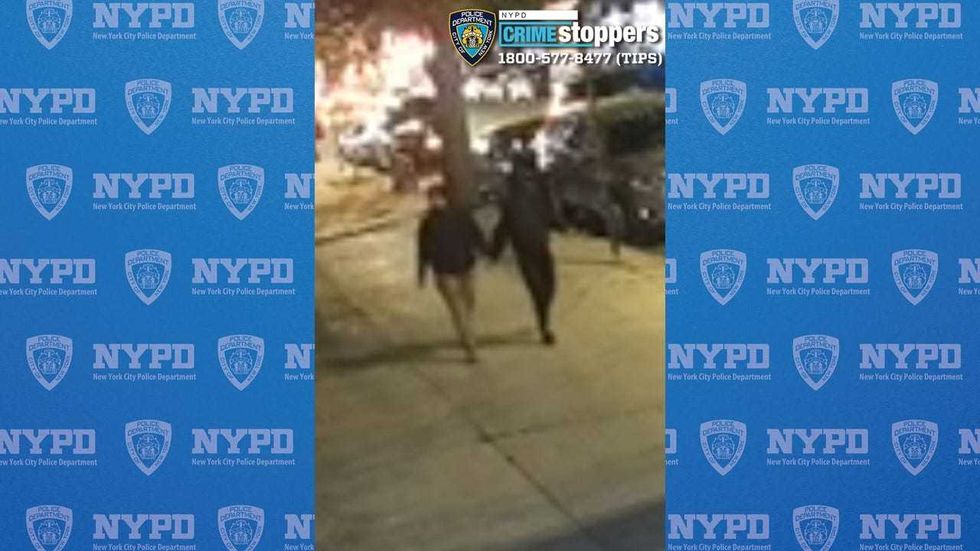 The suspects attacked and robbed the woman before fleeing on foot, police said