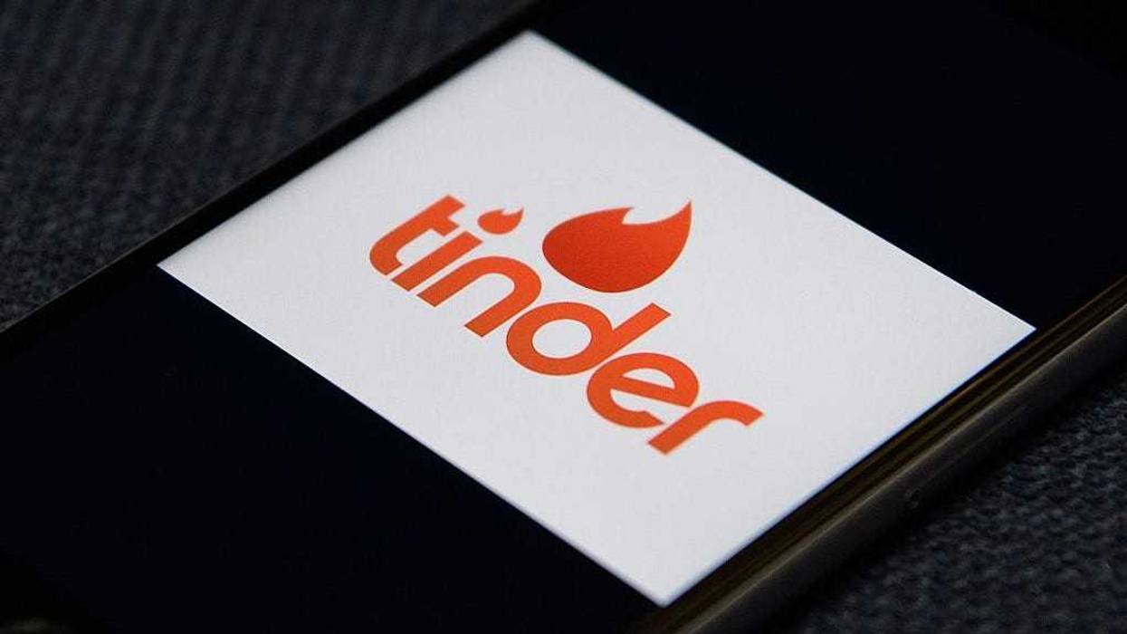The "Tinder" app logo is seen on a mobile phone screen on November 24, 2016 in London, England.