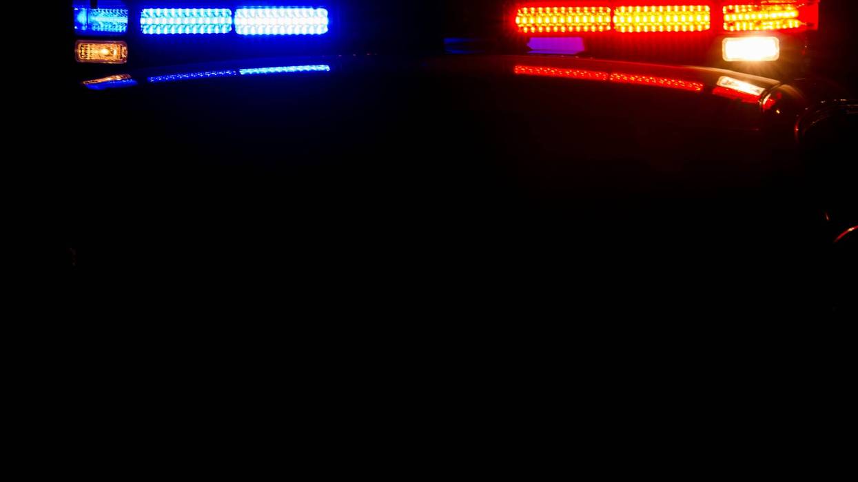 The top of a police car at night with its lights on