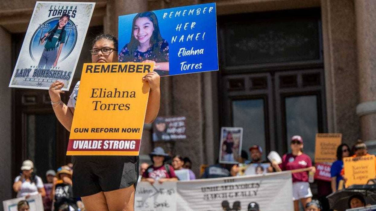 The Torres family stand holding signs of Eliahna Torres, one of the children murdered during the mass shooting at Robb Elementary School, during a March For Our Lives rally on August 27, 2022 in Austin, Texas. 'March For Our Lives' and activists rallied with parents from Uvalde and Santa Fe at the Texas Capitol, where they demanded that Gov. Greg Abbott calls a special session to raise the minimum age to 21 for the purchase of assault weapons. (Photo by Brandon Bell/Getty Images)