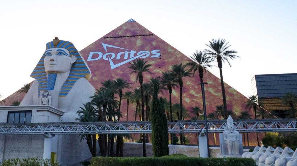 The triangular, Las Vegas Strip side of Luxor Hotel and Casino is covered in an orange advertisement for Doritos ahead of Super Bowl LVIII on January 30, 2024 in Las Vegas, Nevada. The game will be played on February 11, 2024, between the Kansas City Chiefs and the San Francisco 49ers at Allegiant Stadium. (Photo by Ethan Miller/Getty Images)