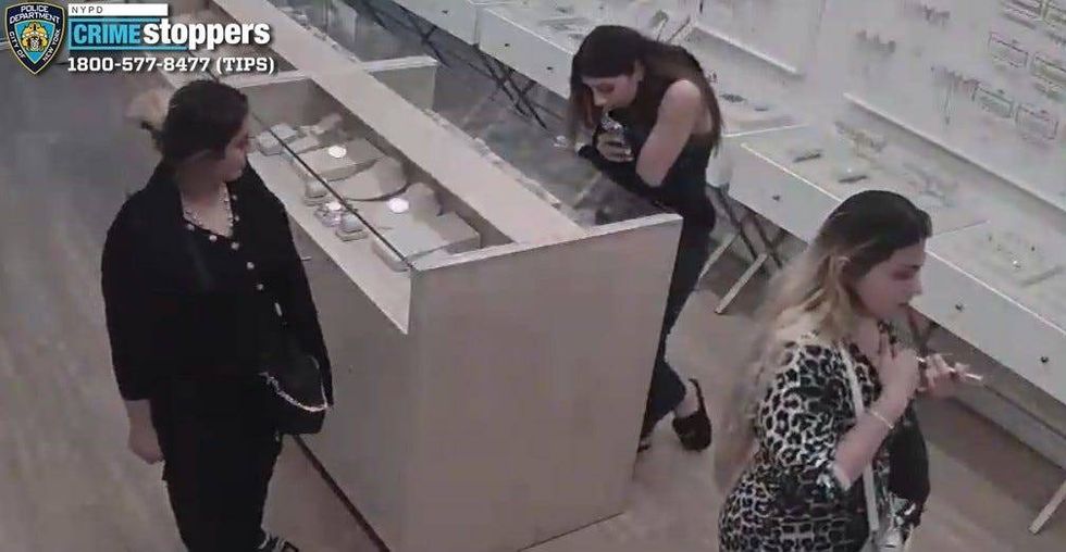 The trio used a coordinated tactic where two suspects would distract a female employee with conversation while the third person removed jewelry from unlocked display cases.