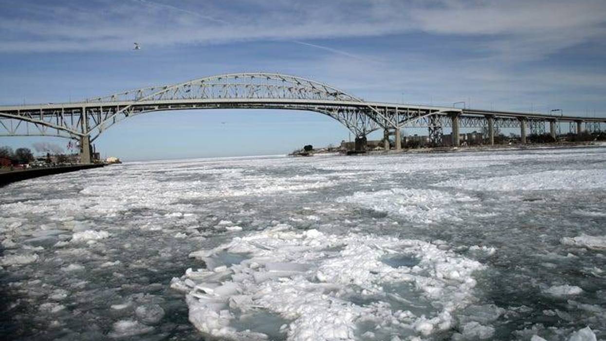 The U.S. and Canadian Coast Guard work together to break up an ice jam in the St. Clair River