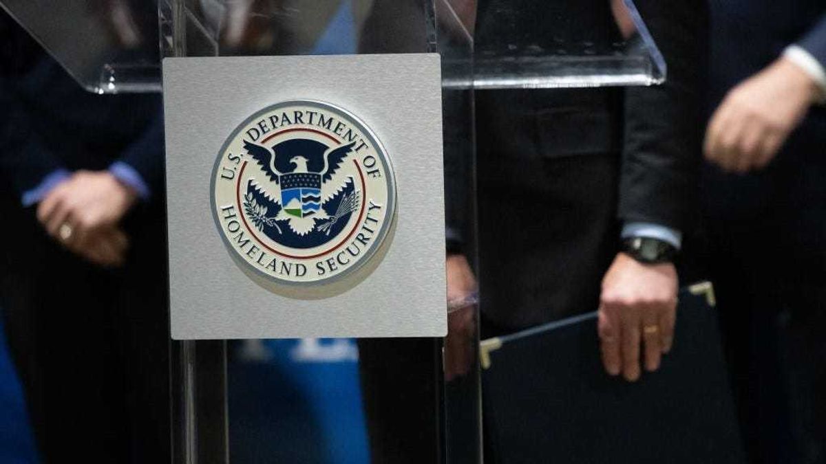 The U.S. Department of Homeland Security seal is seen as DHS Secretary Alejandro Mayorkas delivers remarks while visiting a FEMA community vaccination center on March 2, 2021 in Philadelphia, Pennsylvania.