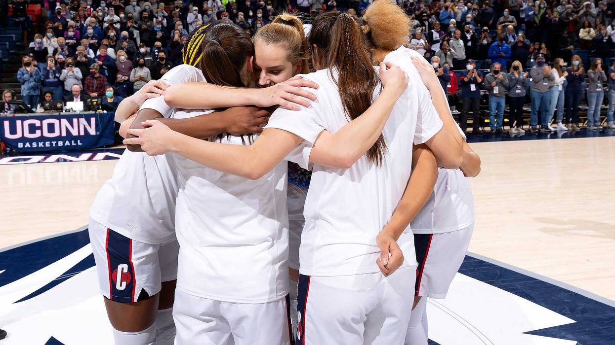 The UConn women celebrate their win over Providence on Sunday.