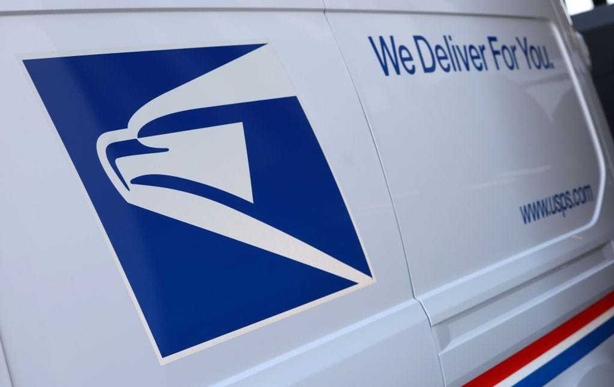 The United States Postal Service logo is seen on a new electric postal vehicle during an event announcing the Postal Service's plan on implementing electric vehicles, at the Postal Service Headquarters on December 20, 2022 in Washington, DC.