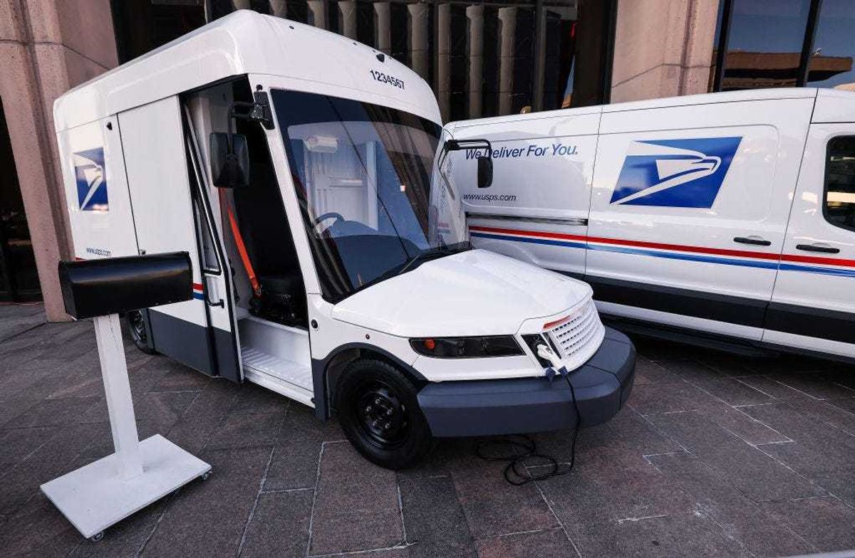 The United States Postal Service unveils two of its battery-powered vehicles at an event announcing its plan on implementing electric vehicles, at the Postal Service Headquarters on December 20, 2022 in Washington, DC.