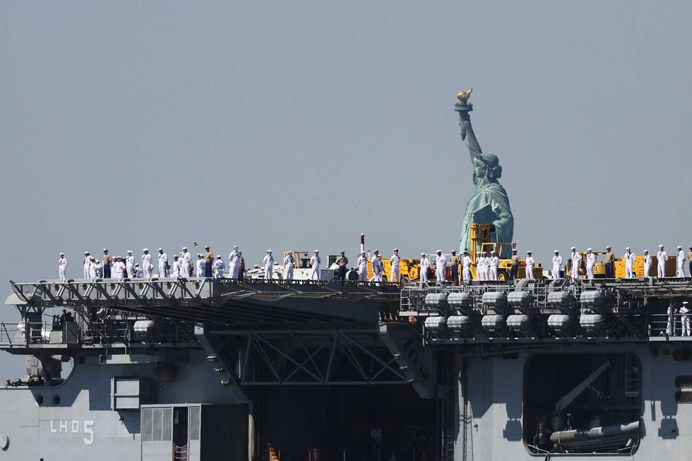 The USS Bataan (LHD-5) sails past the Statue of Liberty as it arrives with the Parade of Ships into New York Harbor during the start of the 36th annual Fleet Week on May 22, 2024 in New York City. The ships travel past the Statue of Liberty and Battery Park in lower Manhattan before ending just below the George Washington Bridge. Fleet Week brings thousands of active service members to New York City for a week of ship tours, concerts, demonstrations and other events that give New Yorkers a close up view of the U.S. military.