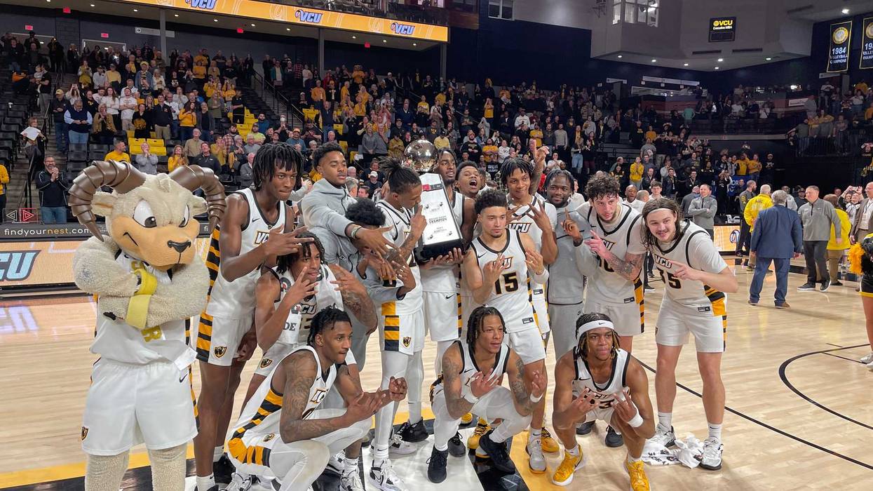 The VCU men's basketball team celebrates after clinching the A-10 regular season title with a win over St. Louis on Tuesday at the Siegel Center.