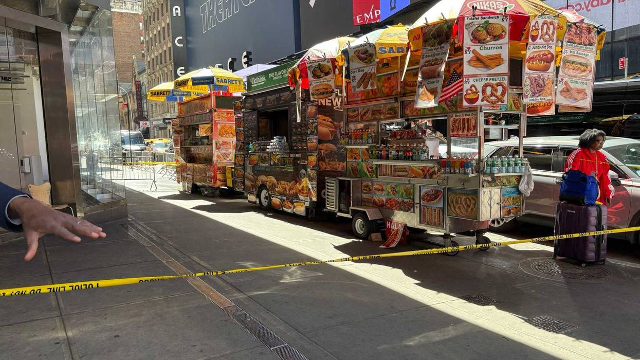The victim was shot at West 47th Street and Seventh Avenue as he tried to stop a fellow vendor from being robbed by a group of people