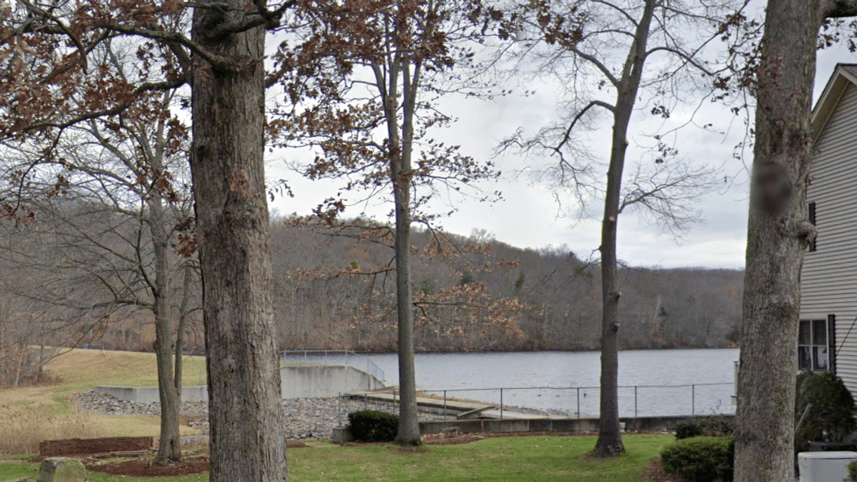 The woman plunged through the ice into Bolton Lake in Vernon around 10:30 a.m. Wednesday, police said