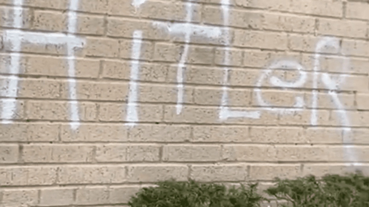 The word "Hitler" scrawled on the wall of a Brooklyn synagogue.