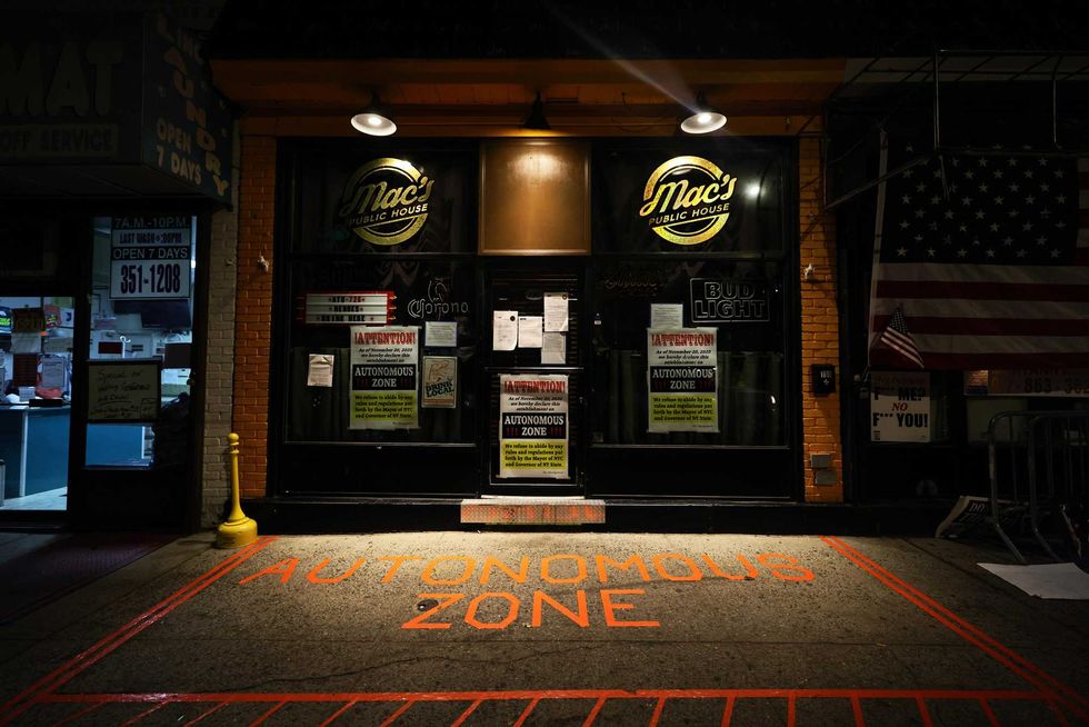 The words "Autonomous Zone" is displayed at the entrance of Mac
