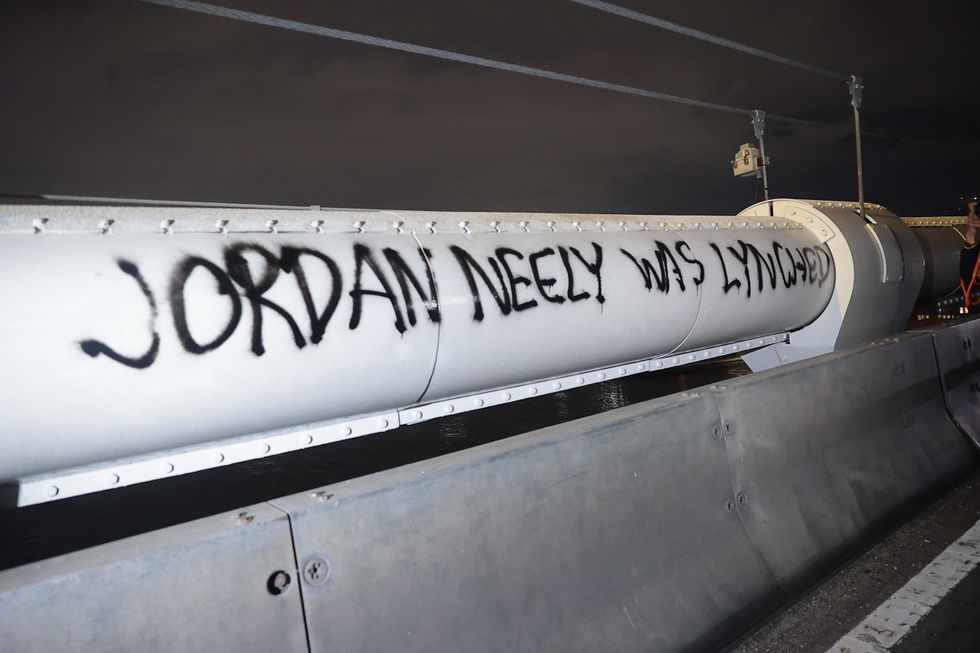 The words "Jordan Neely was lynched" are seen spray-painted on the Manhattan Bridge as protesters crossed the bridge on on May 4, 2023