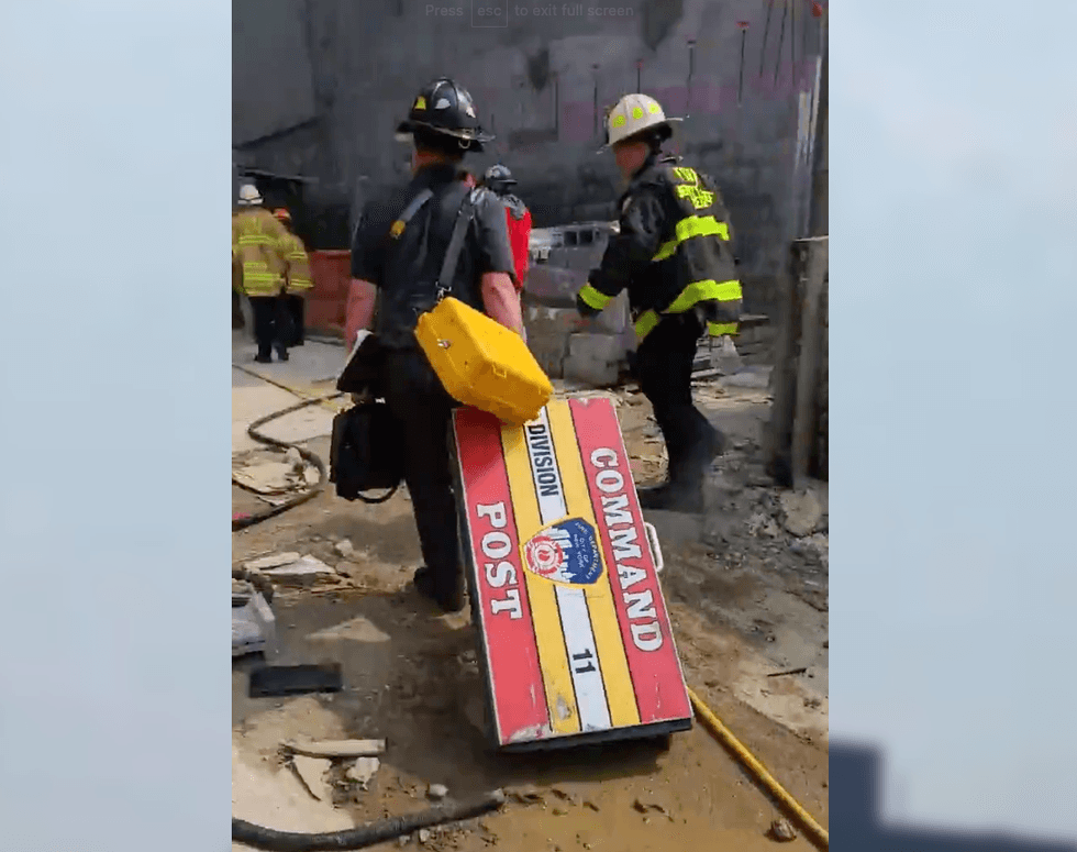 The worker was being evaluated at the scene after he was freed from waist-high rubble