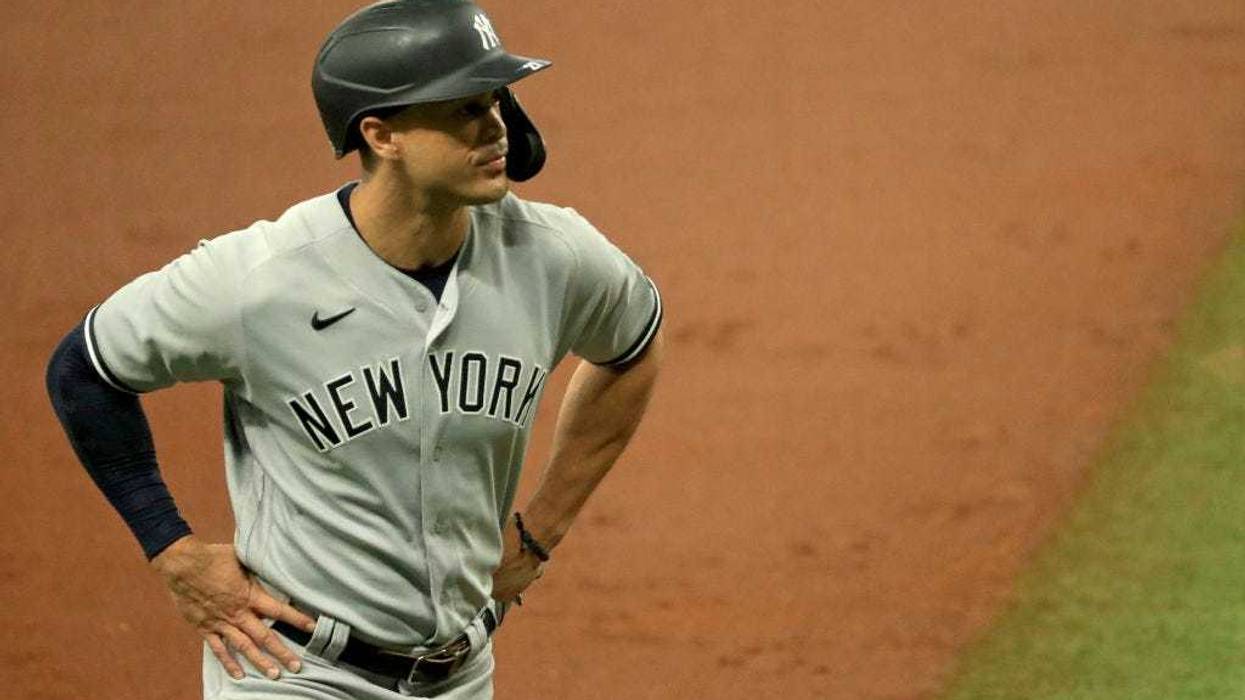 The Yankees' Giancarlo Stanton hits a two-run homer in the first inning against the Toronto Blue Jays on March 29, 2018, at the Rogers Centre in Toronto.