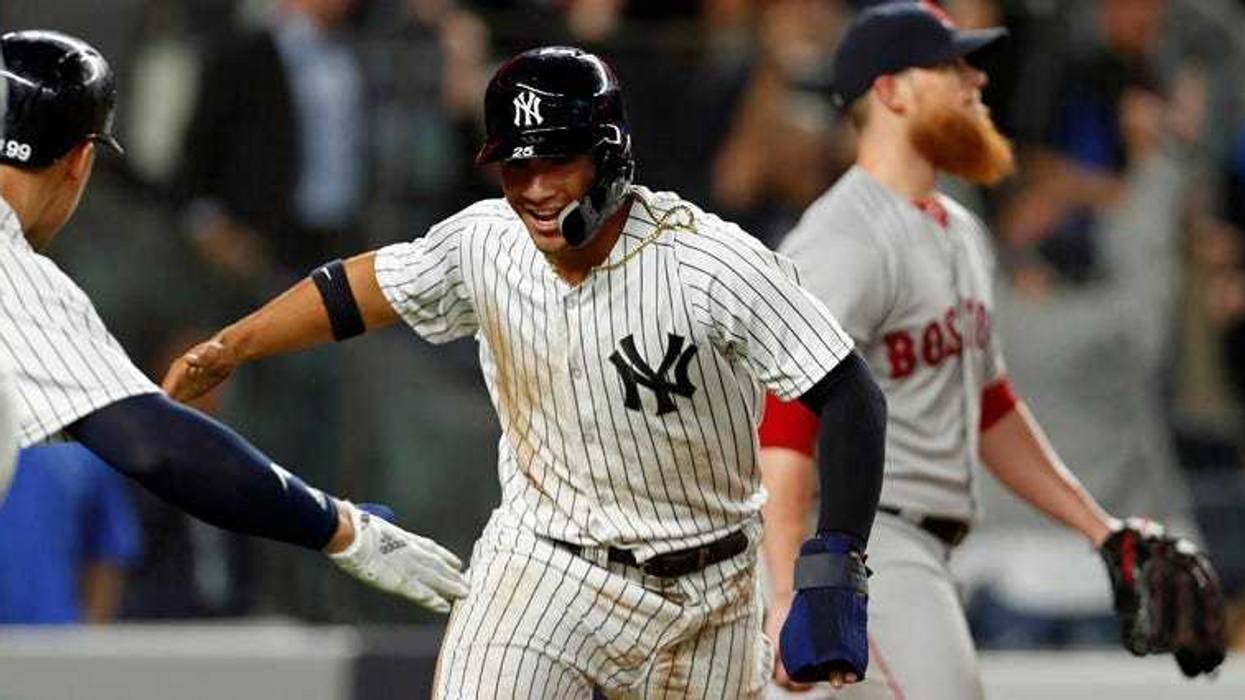 The Yankees' Gleyber Torres (25) celebrates scoring a run against the Red Sox on May 9, 2018, at Yankee Stadium.