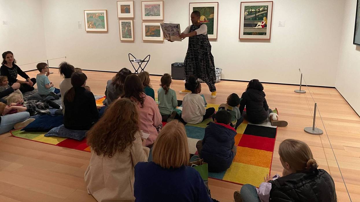 Thembi Palmer reads a book about artist Elijah Pierce to children at the Philadelphia Museum of Art.