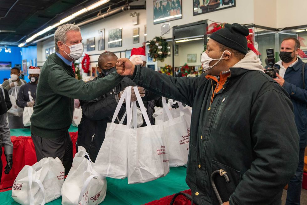 Then-Mayor Bill De Blasio celebrates Christmas by handing out meals the community at the National Action Network