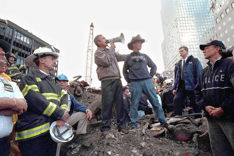 Then–President George W. Bush speaks to rescue workers, firefighters and police officers from the rubble of Ground Zero on Sept. 14, 2001. Bob Beckwith is standing beside him