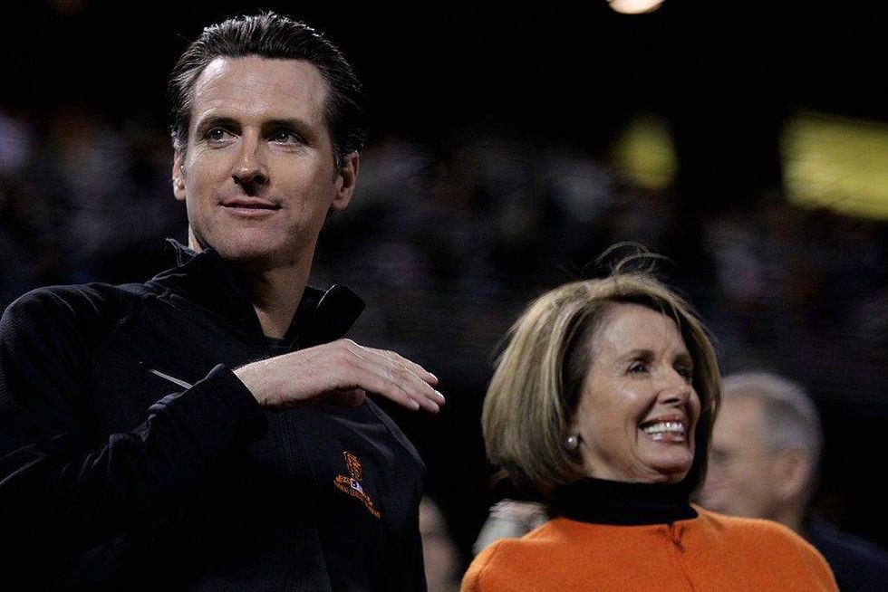 Then San Francisco Mayor Gavin Newsom and U.S. Speaker of the House Rep. Nancy Pelosi (D-CA) in the stands during Game Two of the 2010 MLB World Series between the Giants and the Texas Rangers at AT&T Park on October 28, 2010 in San Francisco, California.