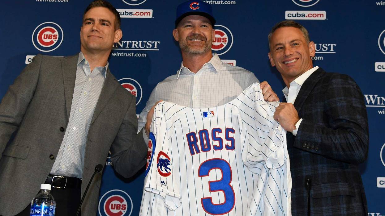 Theo Epstein, president of baseball operations of the Chicago Cubs, (L) David Ross, new manager of the Chicago Cubs (C) and Jed Hoyer, general manager of the Cubs (R) pose for a photo as Ross is introduced to the media at Wrigley Field on October 28, 2019
