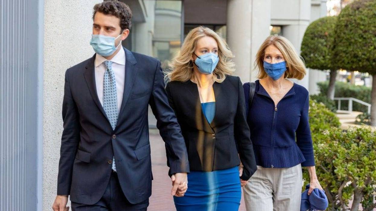 Theranos founder and former CEO Elizabeth Holmes along with her mother Noel Holmes (R) and partner Billy Evans arrive for her trial at the Robert F. Peckham Federal Building November 22, 2021 in San Jose, California.
