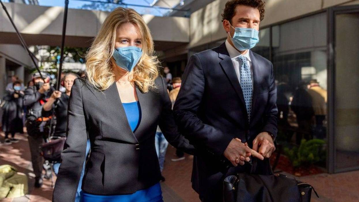 Theranos founder and former CEO Elizabeth Holmes along with her partner Billy Evans (R) depart the Robert F. Peckham Federal Building on November 22, 2021 in San Jose, California.