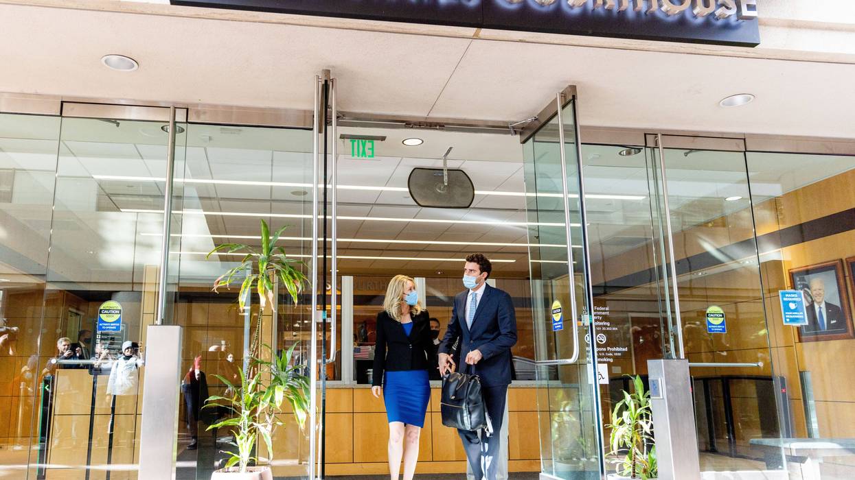 Theranos founder and former CEO Elizabeth Holmes along with her partner Billy Evans (R) depart the Robert F. Peckham Federal Building on November 22, 2021 in San Jose, California.