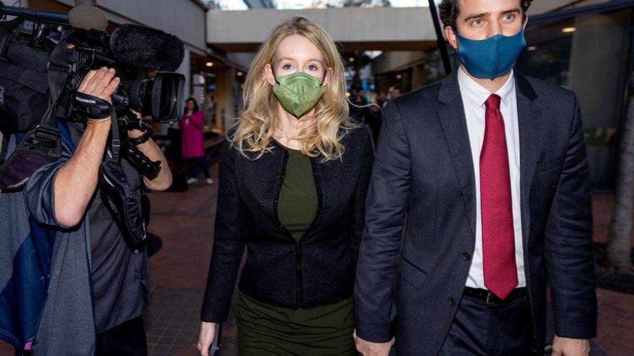 Theranos founder and former CEO Elizabeth Holmes along with her partner Billy Evans (R) leave the Robert F. Peckham Federal Building on November 23, 2021 in San Jose, California.