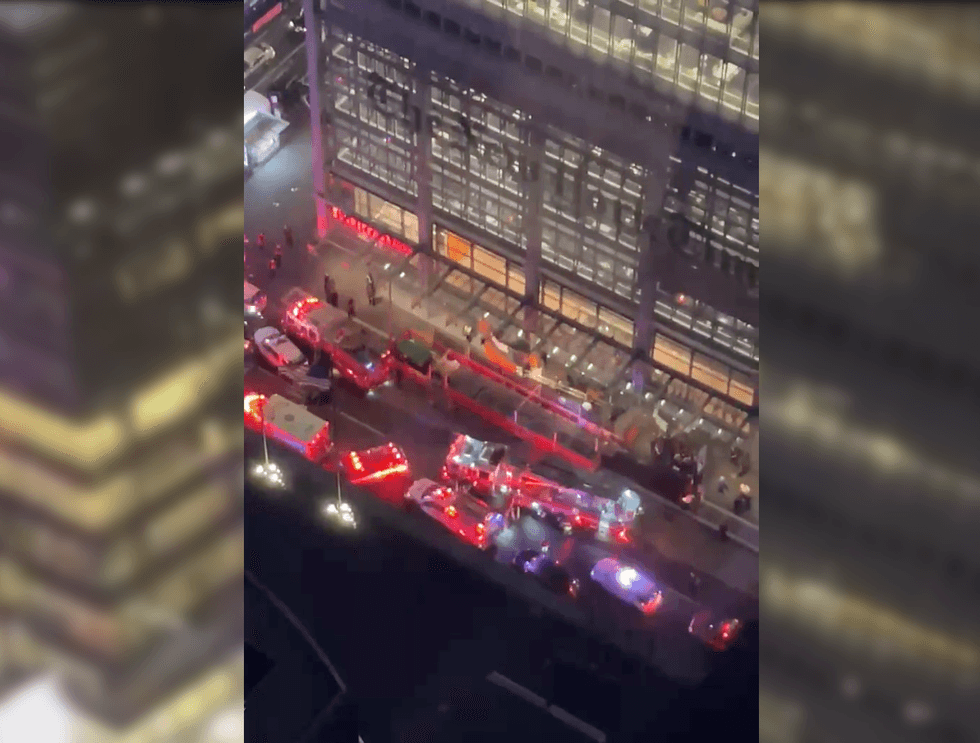 There was a heavy emergency response outside the New York Times building around 7:30 p.m. Tuesday as crowds watched the man climb the tower