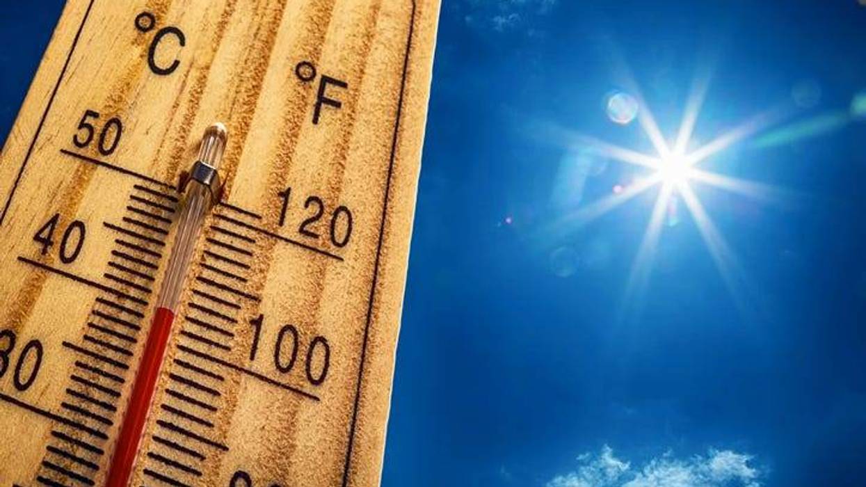 thermometer at 100 degrees with sky in the background
