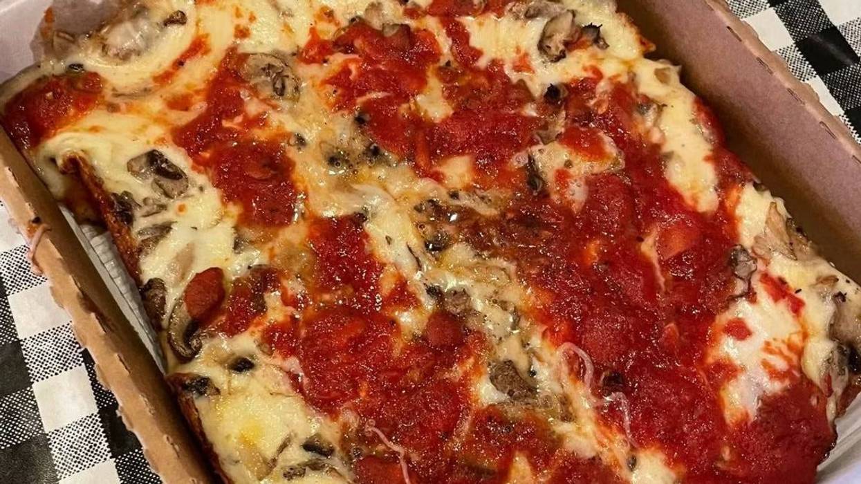 Thick-crust rectangular pizza with melted cheese, tomato sauce, pepperoni, and mushrooms in a box.