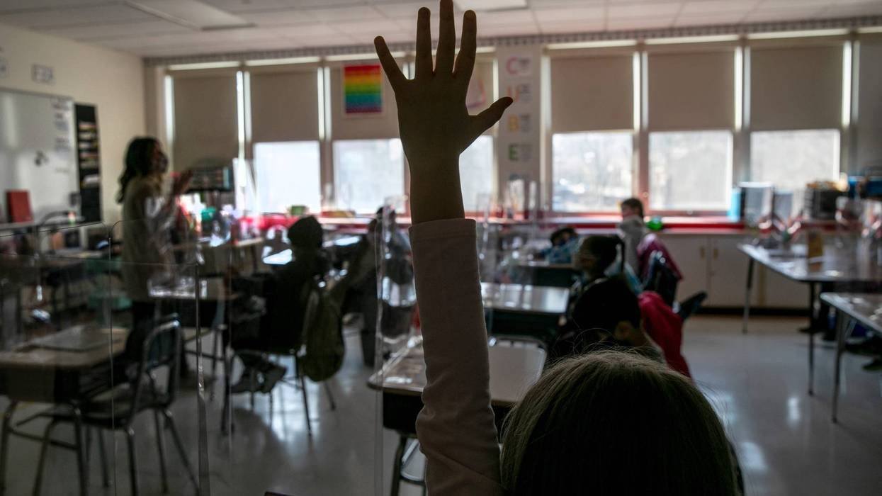 Third grade literacy instructor Katelyn Battinelli (L), speaks with students about their pandemic-related fears on the first day of in-person learning for five days per week at Stark Elementary School on March 10, 2021 in Stamford, Connecticut