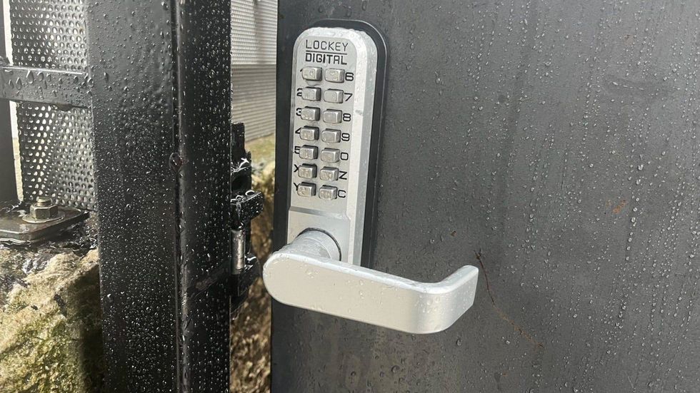 This gate at the property that was broken into has been broken since the beginning of the year, said a next-door neighbor