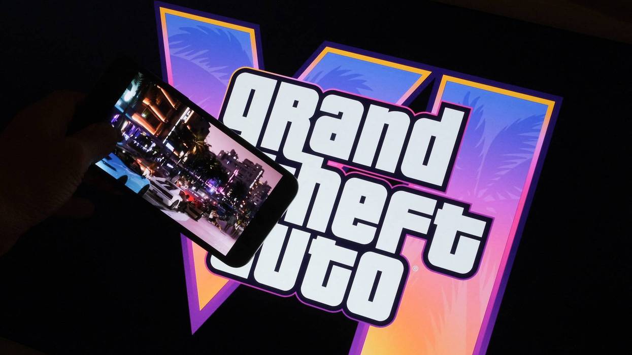 This illustration photo created in Los Angeles, December 4, 2023, shows Rockstar Games' Grand Theft Auto VI trailer played on a screen in front of the game title.