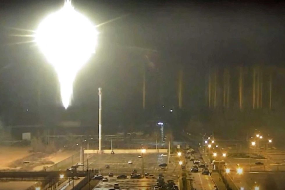 This image made from a video released by Zaporizhzhia nuclear power plant shows bright flaring object landing in grounds of the nuclear plant in Enerhodar, Ukraine Friday, March 4, 2022