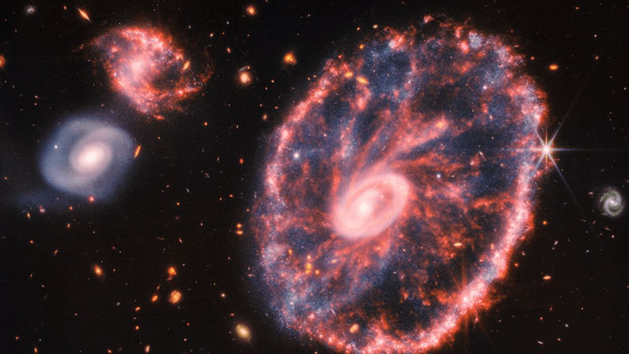 This image of the Cartwheel and its companion galaxies is a composite from Webb’s Near-Infrared Camera (NIRCam) and Mid-Infrared Instrument (MIRI), which reveals details that are difficult to see in the individual images alone.