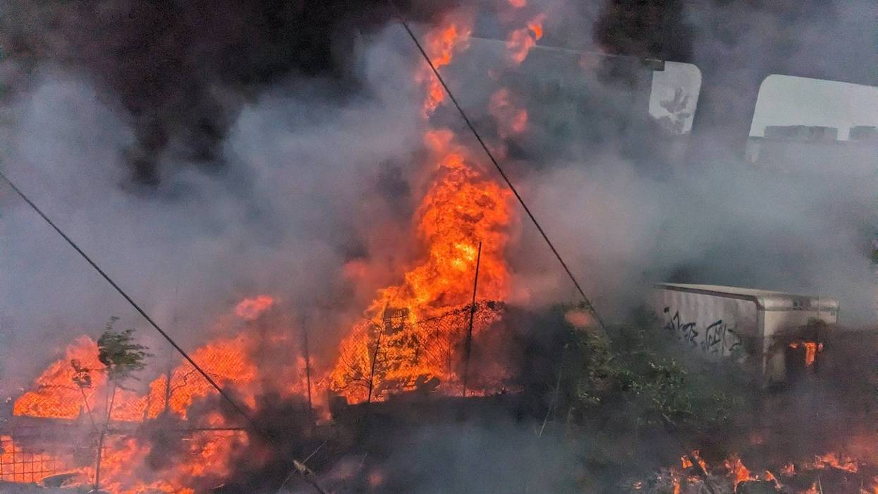 This image taken by a train passenger on SEPTA's Trenton Line shows the intensity of a three-alarm fire at a junk yard and recycling facility in the area of Harbison Street and Torresdale Avenue in Northeast Philadelphia.