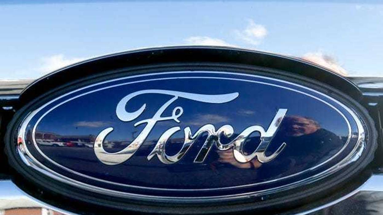 This Nov. 19, 2015 file photo shows the blue Ford oval badge in the grill of a pickup truck