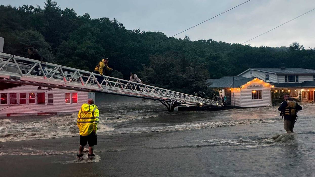 This photo provided by Beacon Hose Co. No. 1, a fire station in Beacon Falls, Connecticut, shows members of Beacon Hose Co. rescuing people from the Brookside Inn in Oxford, Conn., Sunday, Aug. 18, 2024