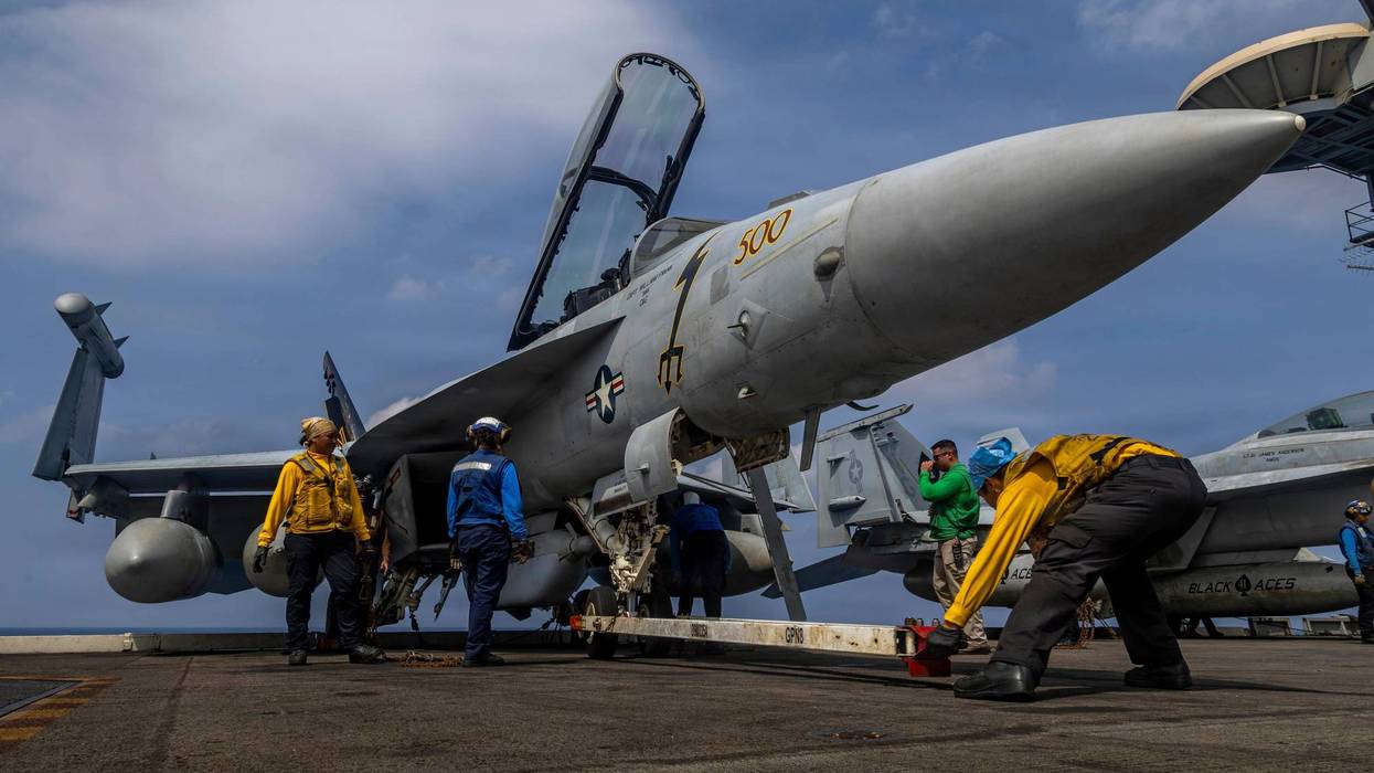 This photo provided by the U.S. Navy shows sailors preparing a Boeing EA-18G Growler on the flight deck of the Nimitz-class aircraft carrier USS Abraham Lincoln in the Indian Ocean on Jan. 21, 2026.