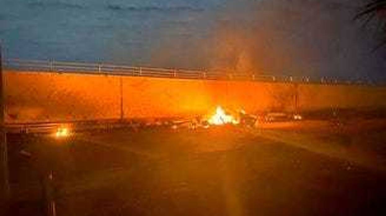 This photo released by the Iraqi Prime Minister Press Office shows a burning vehicle at the Baghdad International Airport following an airstrike, in Baghdad, Iraq, early Friday, Jan. 3, 2020. (Iraqi Prime Minister Press Office via AP)